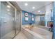 Well-appointed bathroom featuring separate shower, tub, and tile surround at 4586 Best Rd, Larkspur, CO 80118