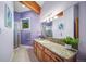 Modern bathroom with granite countertop vanity, shower, tile floors, and natural light at 4586 Best Rd, Larkspur, CO 80118