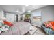 Sunlit bedroom with gray walls, bright windows and calming decor at 4586 Best Rd, Larkspur, CO 80118