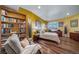 Bedroom with built-in bookshelf, wood floors, desk and a light color palette at 4586 Best Rd, Larkspur, CO 80118