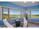 Seating area with picture windows showing expansive green, rolling hills, and distant mountains at 4586 Best Rd, Larkspur, CO 80118