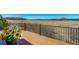 Wood deck with railing that provides views of plains and mountains; flower pot in foreground at 4586 Best Rd, Larkspur, CO 80118