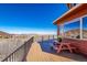 Large wood deck with plains and mountain views, railing, and picnic table, perfect for outdoor enjoyment at 4586 Best Rd, Larkspur, CO 80118