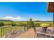 Outdoor deck with dining area, great views of green pastures and mountains at 4586 Best Rd, Larkspur, CO 80118