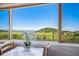 Bright dining area with scenic views overlooking green hills and clear skies at 4586 Best Rd, Larkspur, CO 80118