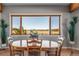 Dining room with mountain views, wood floors, and a large window that brings in natural light at 4586 Best Rd, Larkspur, CO 80118