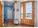 Inviting entryway with decorative glass door and views of the surrounding landscape at 4586 Best Rd, Larkspur, CO 80118