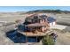 Aerial elevation showcasing wrap around deck, solar panels, and two-car garage at 4586 Best Rd, Larkspur, CO 80118