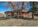 Charming home exterior, set in grassy yard with mature trees and outdoor seating at 4586 Best Rd, Larkspur, CO 80118