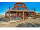 Stunning exterior view featuring a spacious deck and rock landscaping at 4586 Best Rd, Larkspur, CO 80118