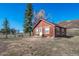 Cozy single-story home with charming red exterior, flower boxes and mountain views at 4586 Best Rd, Larkspur, CO 80118