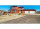 Exterior elevation showing large deck, solar panels, two-car garage, and circular driveway at 4586 Best Rd, Larkspur, CO 80118