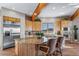 Charming kitchen with light wood cabinets, stainless appliances, and an island with bar seating at 4586 Best Rd, Larkspur, CO 80118