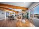 Bright kitchen and dining area with hardwood floors, exposed beams, and mountain views at 4586 Best Rd, Larkspur, CO 80118