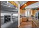 Bright kitchen featuring stainless steel appliances, wood cabinets, granite counters, and wood floors at 4586 Best Rd, Larkspur, CO 80118