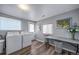 Practical laundry room with laminate flooring, and folding table at 4586 Best Rd, Larkspur, CO 80118