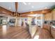 Open floor plan with hardwood floors, wooden beams, kitchen island, and a spacious living area at 4586 Best Rd, Larkspur, CO 80118
