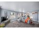 Inviting living room with plush gray sectional, lots of windows and an open floor plan at 4586 Best Rd, Larkspur, CO 80118