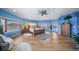 Expansive main bedroom with blue walls and large windows showcasing the scenic countryside at 4586 Best Rd, Larkspur, CO 80118