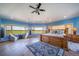 Expansive main bedroom with panoramic views, hardwood floors, and a cozy seating area at 4586 Best Rd, Larkspur, CO 80118