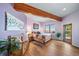 Cozy main bedroom with hardwood floors, wooden ceiling beams, and views of the plains at 4586 Best Rd, Larkspur, CO 80118