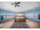 Spacious main bedroom featuring ample natural light, light wood floors, and a statement area rug at 4586 Best Rd, Larkspur, CO 80118