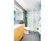Modern bathroom featuring an open glass shower with white and gray tiling at 1497 S Fairfax St, Denver, CO 80222