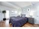 Spacious bedroom with a bed, bench, hardwood floors, natural light and decor at 1497 S Fairfax St, Denver, CO 80222