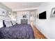 Well-lit bedroom featuring hardwood floors, an adjacent view of the kitchen and decor at 1497 S Fairfax St, Denver, CO 80222