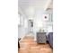 Bedroom with an attached bathroom featuring hardwood floors, natural light and art pieces at 1497 S Fairfax St, Denver, CO 80222
