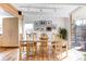 Open dining area with hardwood floors, a large table, and natural light at 1497 S Fairfax St, Denver, CO 80222