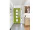 Bright entryway with a stylish green door, modern tile floors, and built-in shelves at 1497 S Fairfax St, Denver, CO 80222