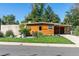 Charming modern home with wood siding, well-manicured lawn, and inviting curb appeal at 1497 S Fairfax St, Denver, CO 80222