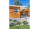 Close-up of modern wood-sided home with unique carport design and manicured landscaping at 1497 S Fairfax St, Denver, CO 80222