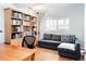 Home office space featuring a wooden bookshelf, a sofa, hardwood floors and natural light at 1497 S Fairfax St, Denver, CO 80222