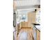 Modern kitchen with stainless steel appliances, light wood cabinetry, and hardwood floors at 1497 S Fairfax St, Denver, CO 80222