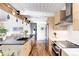 Bright, open kitchen featuring a large island, stainless appliances, and hardwood floors at 1497 S Fairfax St, Denver, CO 80222