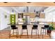 Stylish kitchen island with bar seating, stainless steel appliances, and hardwood floors at 1497 S Fairfax St, Denver, CO 80222