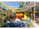 Relaxing patio area featuring stylish furniture, a grill, and decorative sunshade at 1497 S Fairfax St, Denver, CO 80222