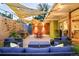 Inviting patio with string lights, comfortable seating, and outdoor dining area for entertaining at 1497 S Fairfax St, Denver, CO 80222
