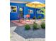 Small patio with table and chairs next to a blue building at 1497 S Fairfax St, Denver, CO 80222