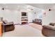 Spacious carpeted basement with a built-in media center and comfortable seating arrangement at 19939 E Belleview Ln, Centennial, CO 80015