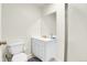 Clean, bright bathroom with white fixtures, including a vanity, toilet, and glass-enclosed shower at 19939 E Belleview Ln, Centennial, CO 80015