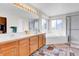 Bright bathroom with double sinks, a soaking tub, and a separate shower at 19939 E Belleview Ln, Centennial, CO 80015