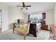 Comfortable bedroom with a vaulted ceiling, ceiling fan, and tasteful decor with lots of light at 19939 E Belleview Ln, Centennial, CO 80015