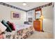 Cozy bedroom with floral accents, features a ceiling fan, and a charming floral border at 19939 E Belleview Ln, Centennial, CO 80015