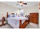 Comfortable bedroom with a wooden bed frame, side tables, and coordinated decor at 19939 E Belleview Ln, Centennial, CO 80015
