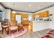 Bright eat-in kitchen featuring wood cabinets, modern appliances, and a cozy dining area at 19939 E Belleview Ln, Centennial, CO 80015