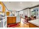 Open kitchen features hardwood floors, modern appliances, and dining area with chairs at 19939 E Belleview Ln, Centennial, CO 80015