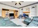 Comfortable living room with a fireplace, shelving, and a mounted television at 19939 E Belleview Ln, Centennial, CO 80015